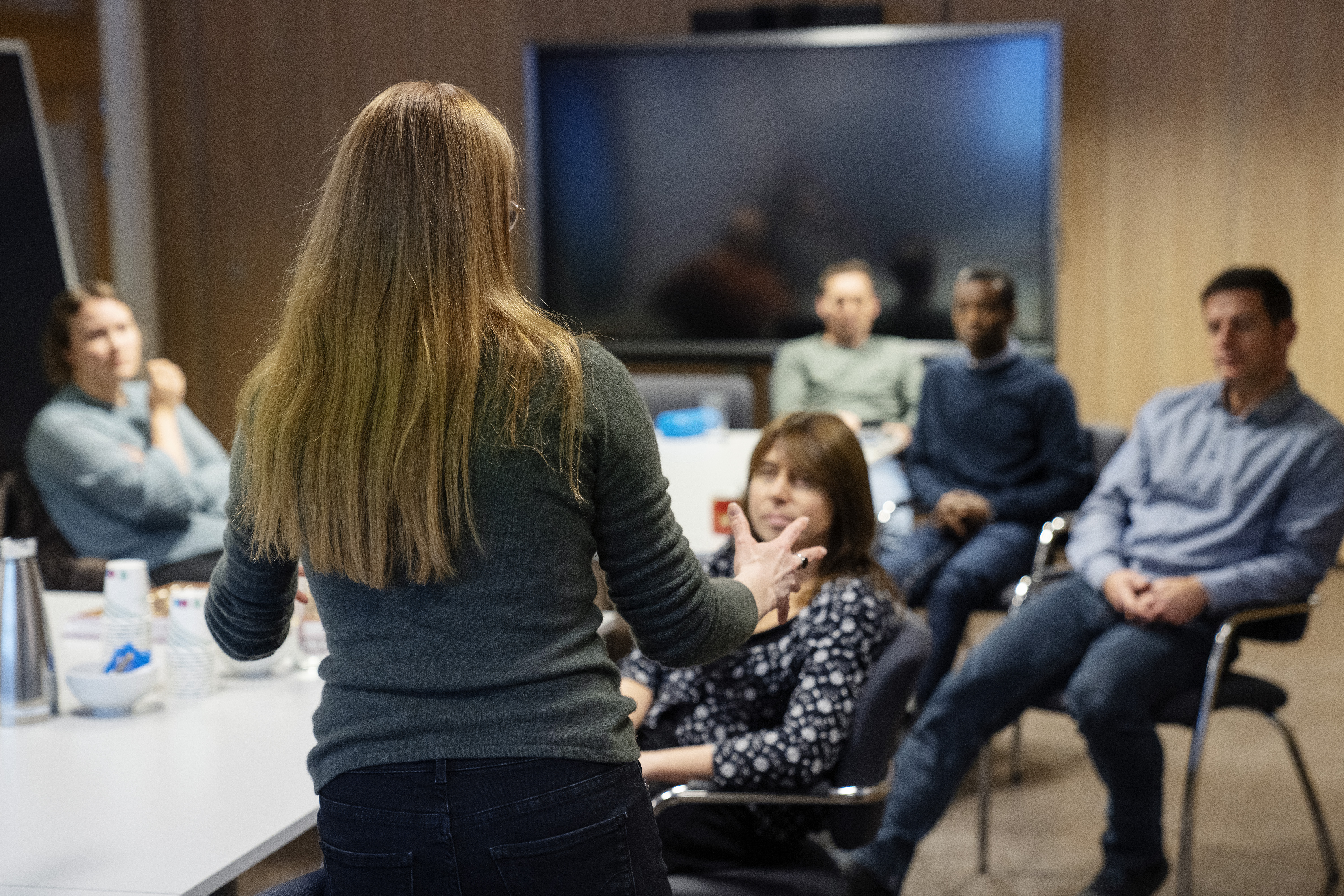 Woman talking in front of a group of people