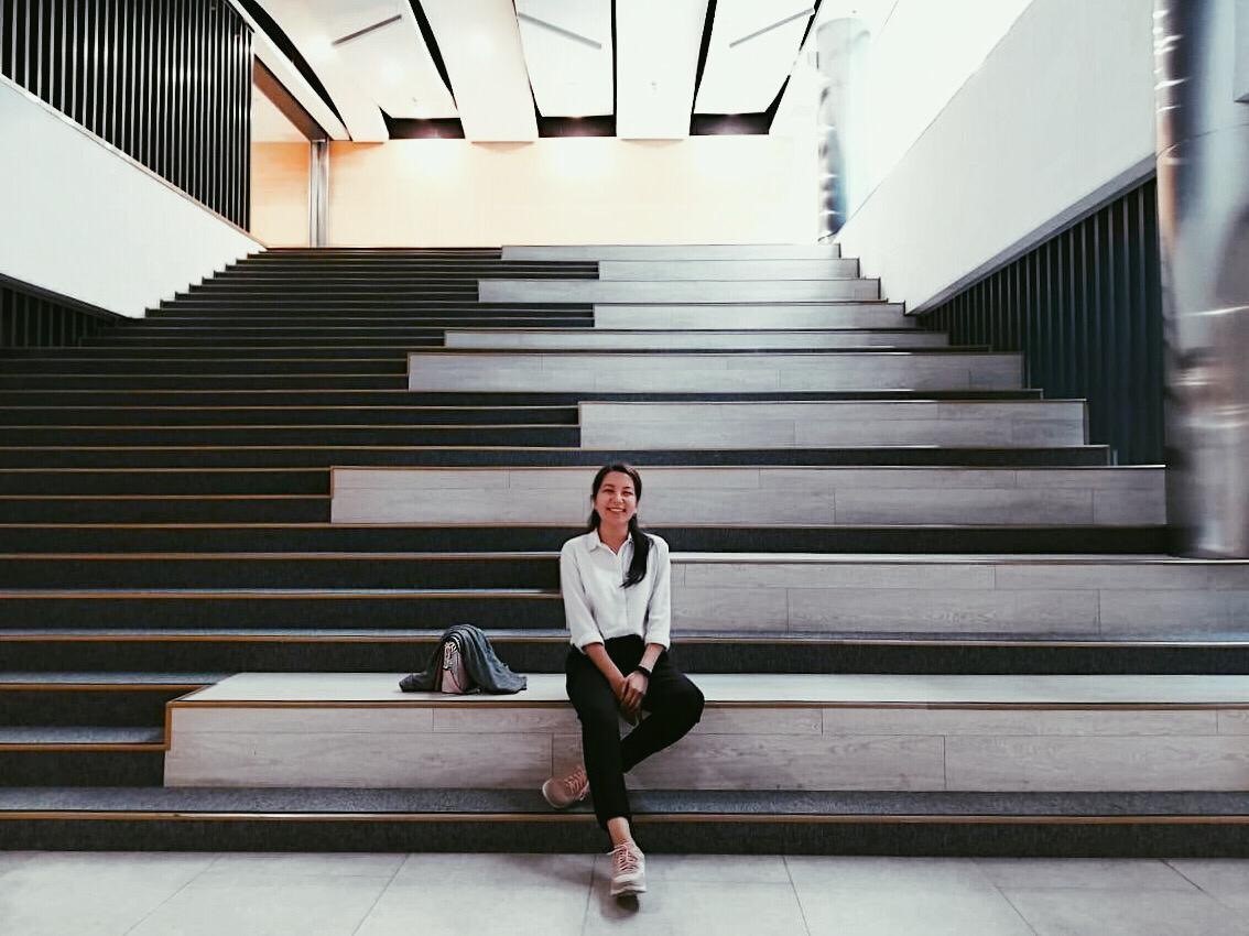 Woman sitting in a staircase