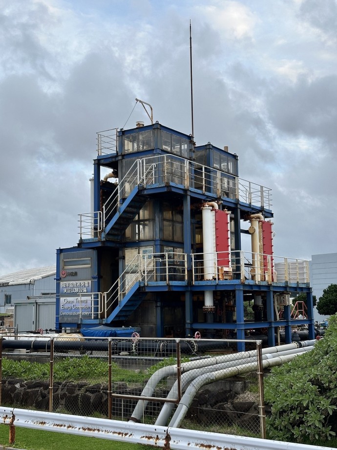 An industrial facility wiht pipes running from it to a culvert