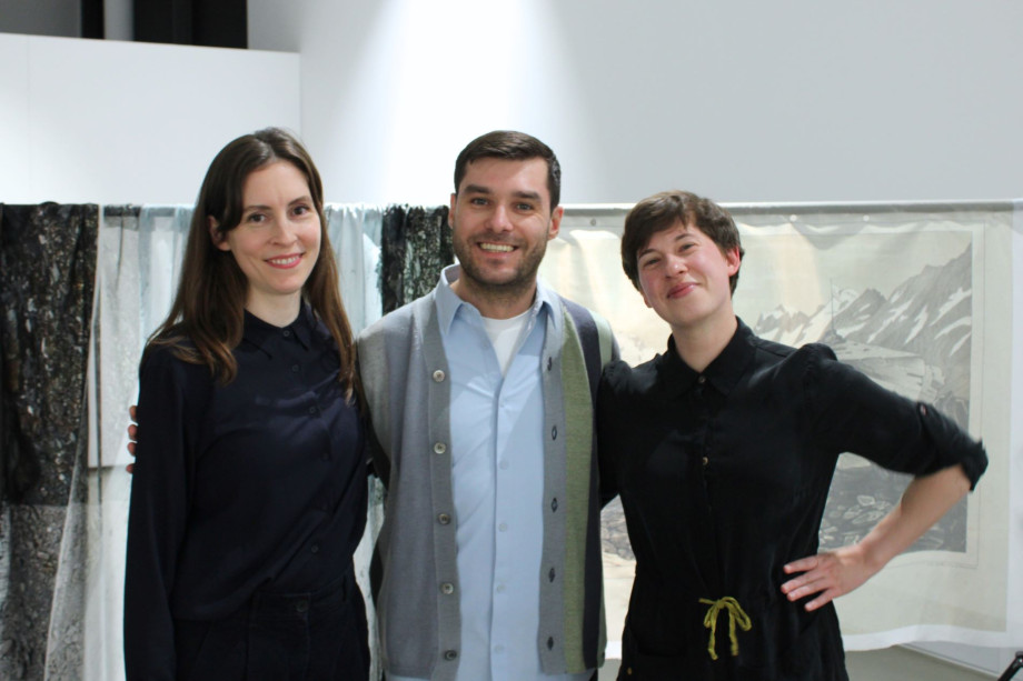 Photograph of two women and one man at an art gallery opening