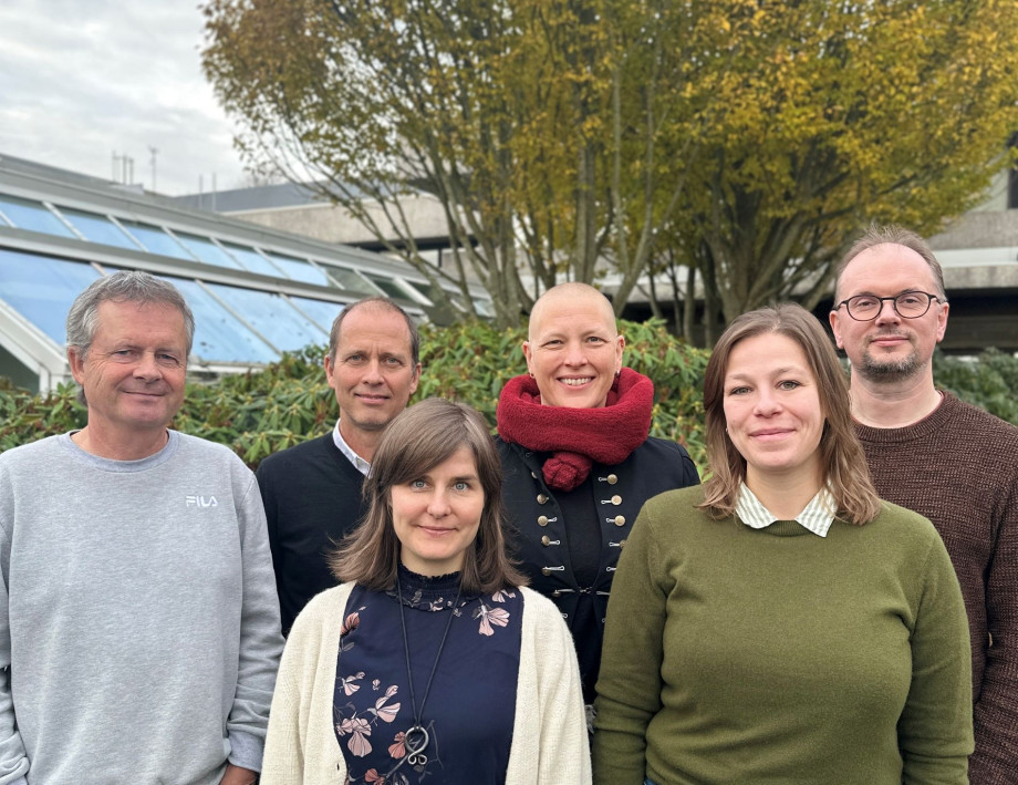 A group of people standing facing the camera